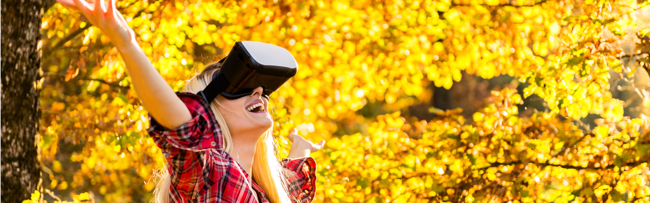 Slideshow picture of girl with virtual reality headset outside during the season of fall.