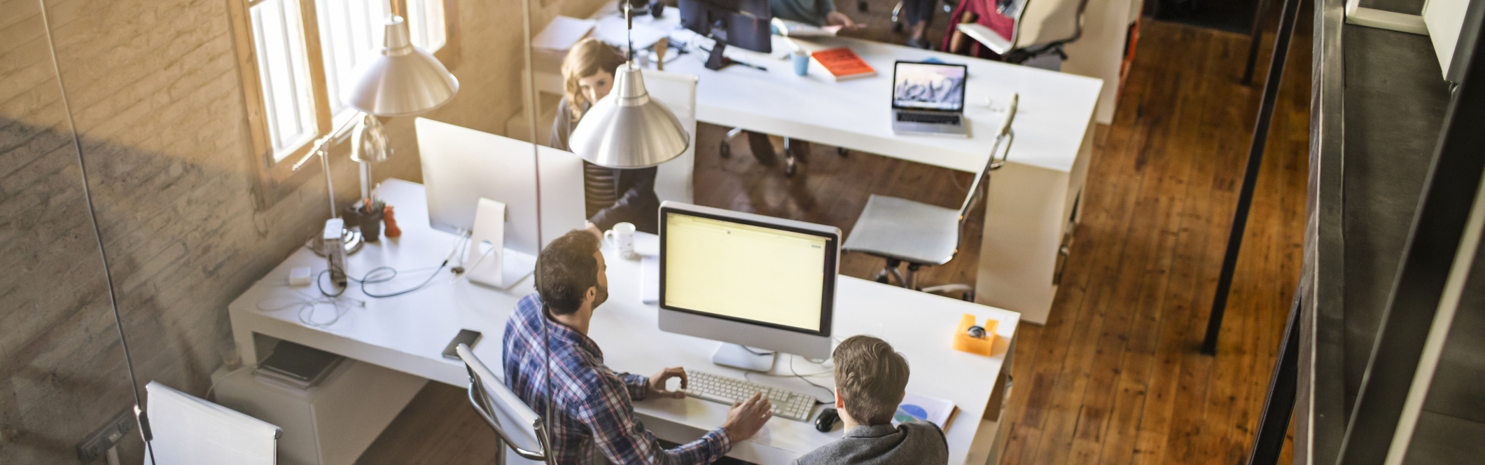 Slideshow picture of a group of people collaborating in an office environment.